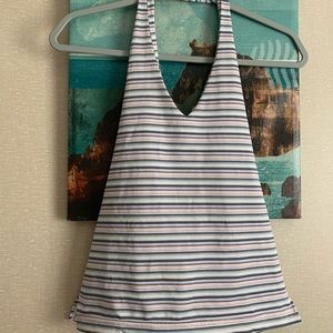 Around the neck no sleeves it’s a juniors large 11/13